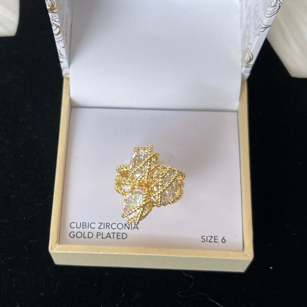 Three stone ring with unique cast in plated gold with cubic zirconia